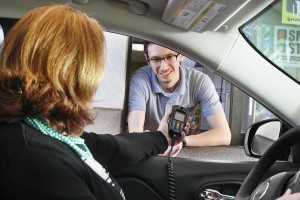 woman in car with ignition interlock and service agent
