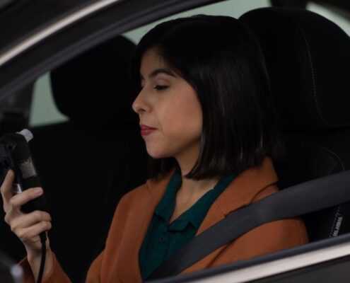 Woman driver checks the results of her Ignition Interlock test