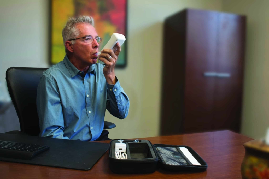 Portable alcohol monitoring technology device SMART Mobile test in an office with the carrying case on desk