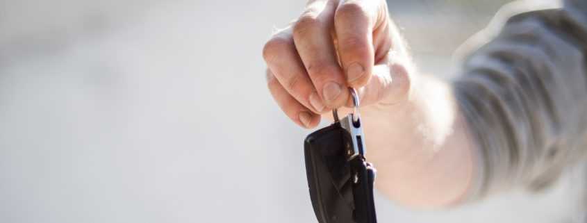 male holding car keys