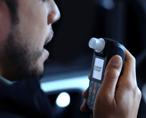 Man in his car about to use an Ignition Interlock Device.