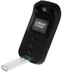 on angle view of the Smart Start Insight, a portable breath alcohol testing device with its screen on with the Smart Start logo on the screen