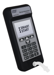 angle view of the Smart Start SmartMobile device, a portable breath alcohol testing unit with its screen on with the Smart Start logo on the screen